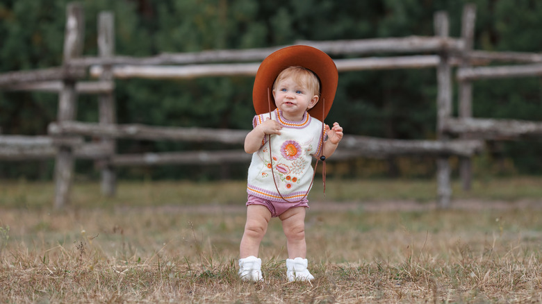 A baby girl in a cowgirl hat