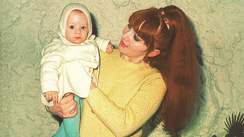 Mom from the '60s holding her baby