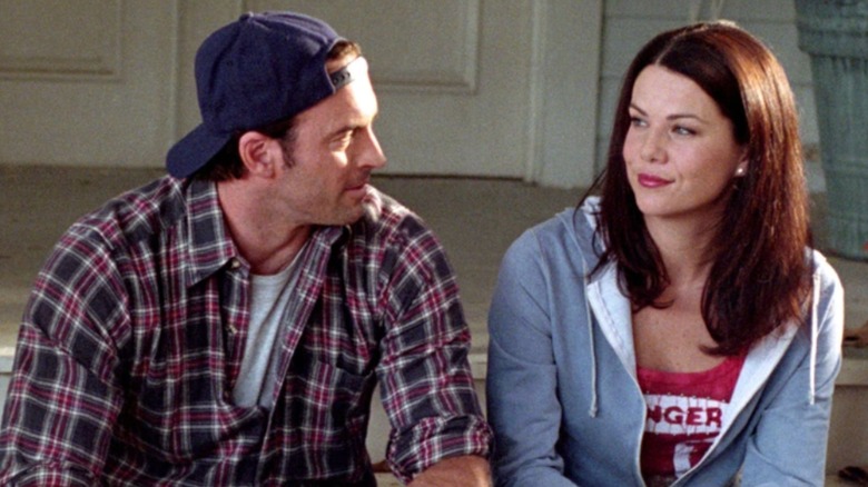 Lauren Graham and Scott Patterson smile at each other while in character as Lorelai Gilmore and Luke Danes in Gilmore Girls