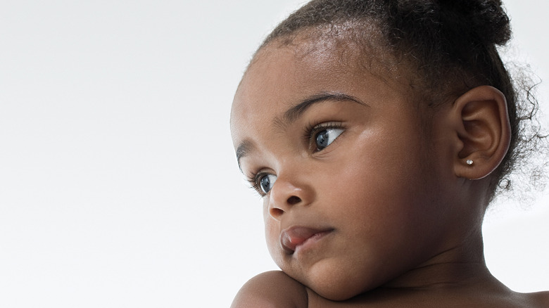 A beautiful toddler looking to one side