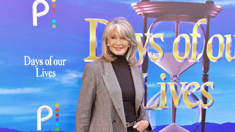 Deirdre Hall in a gray blazer at a red carpet event.