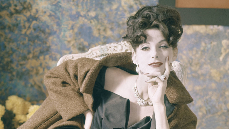 Anne Sante-Marie modeling a black gown and a coat