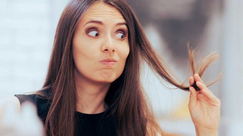 woman looking at hair