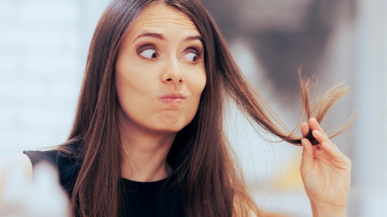 woman looking at hair 