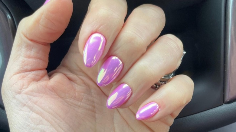 woman with pink chrome nails 