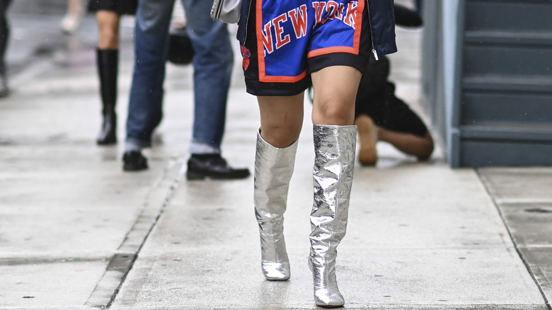 Basketball shorts, tall silver boots