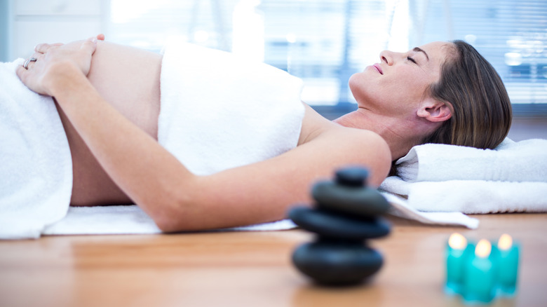 A pregnant woman relaxing at the spa