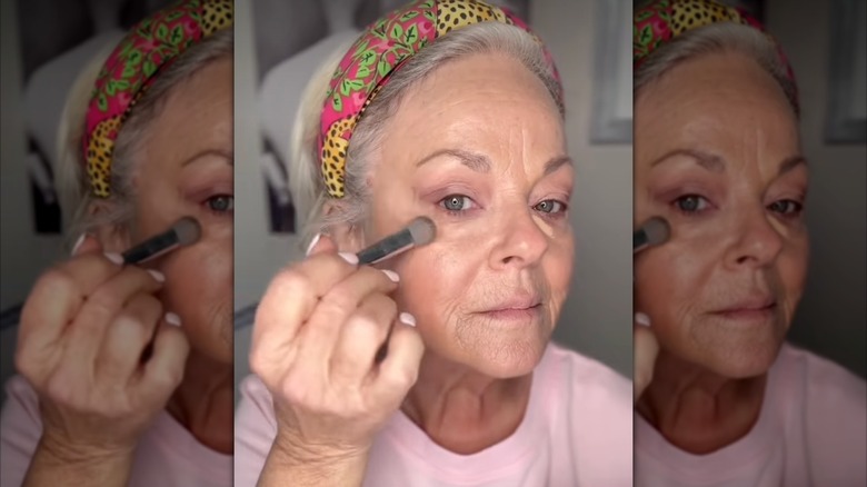 A woman applying a dewy foundation