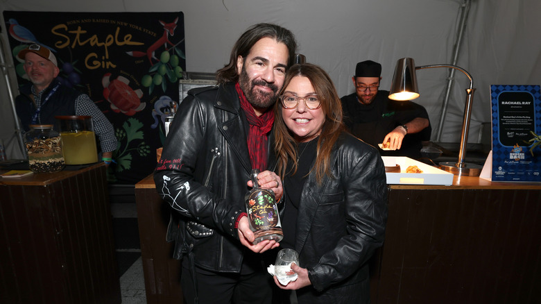 Rachel Ray and John Cusimano pose at the Staple Gin booth during the Blue Moon Burger Bash 2.0 presented by Pat LaFrieda Meats hosted by Brooklyn Beckham and Rachael Ray hosted by Food Network New York City Wine & Food Festival presented by Invesco QQQ on October 17, 2025