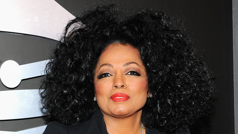 Diana Ross performs at a microphone in front of an audience