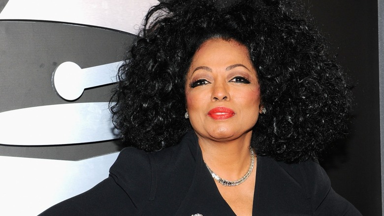 Diana Ross performs at a microphone in front of an audience