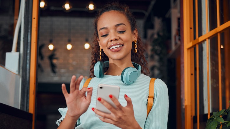 stylish woman using smartphone