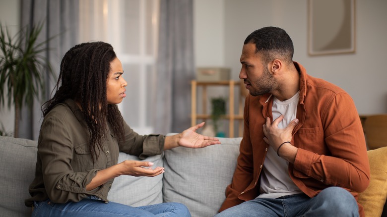 couple arguing on the couch