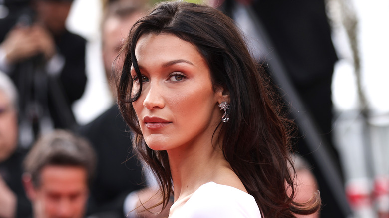 Bella Hadid looking over shoulder with loose wavy hair