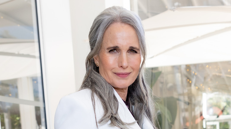 Andie McDowell posing with straight gray hair