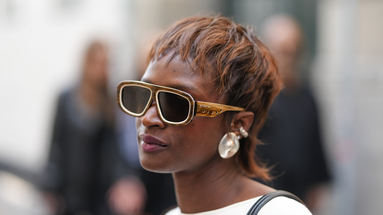 Woman with a long pixie haircut and sunglasses