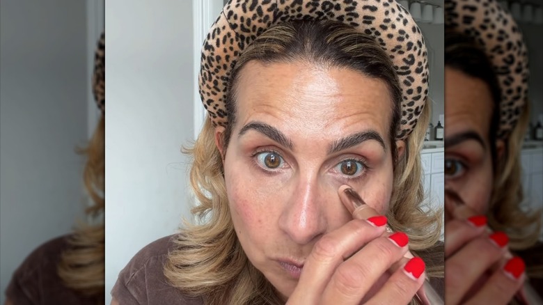Woman applying Dibs stick concealer