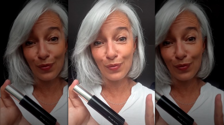 Mature woman holding Merit mascara