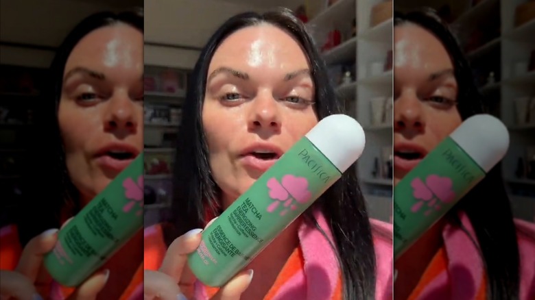 Woman holding up Pacifica Matcha Tea essence