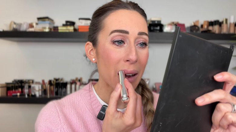 Woman applying Dior lipstick