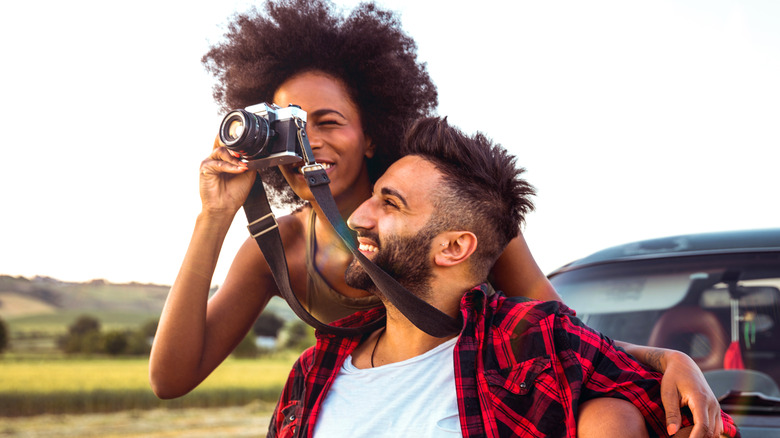 woman with man taking photo