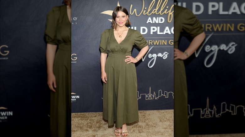 Bindi Irwin in a floor-length olive green V-neck fit-and-flare dress at the 2024 Steve Irwin Gala.