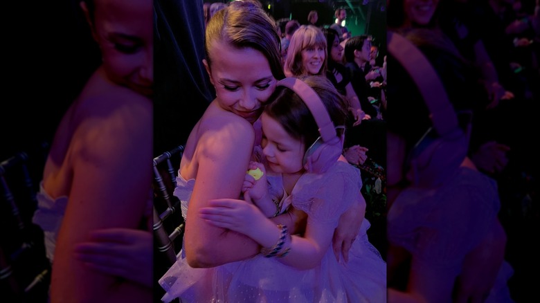 Bindi Irwin and daughter Grace Irwin Powell hugging, sitting in the audience of DWTS