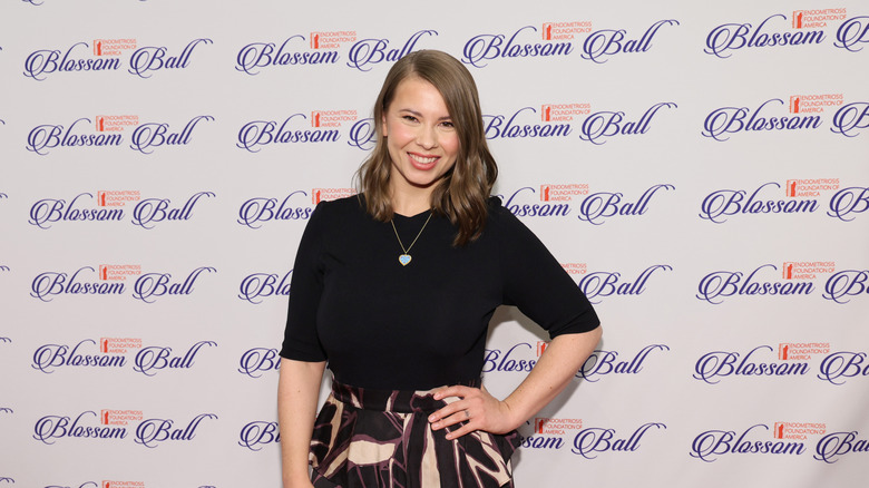 Bindi Irwin in a black shirt and printed skirt at the 2024 EndoFound Blossom Ball