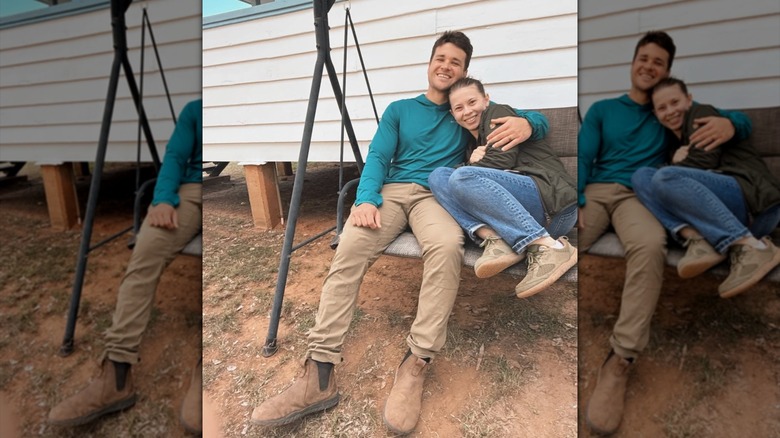Bindi Irwin and Chandler Powell cuddling on a swing