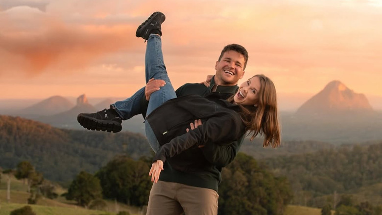 Chandler Powell holding Bindi Irwin while both are laughing