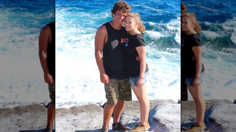 Bindi Irwin and Chandler Powell posing by the sea