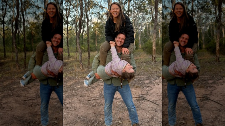 Chandler Powell holding Bindi Irwin and daughter Grace