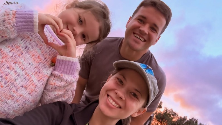Bindi Irwin, Chandler Powell, and daughter Grace Warrior Irwin Powell smile for a family selfie