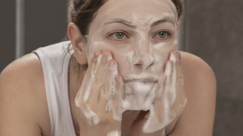 woman washing her face