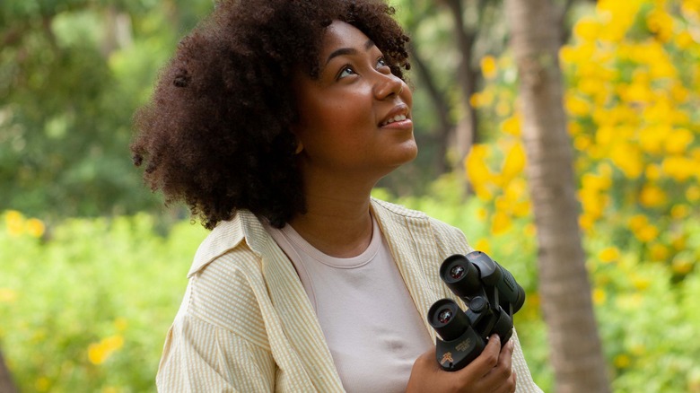 Woman birdwatching with binoculars