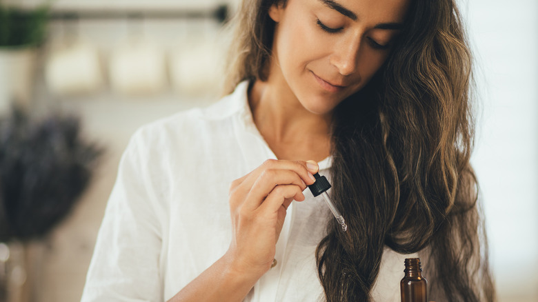 Woman using a hair oil