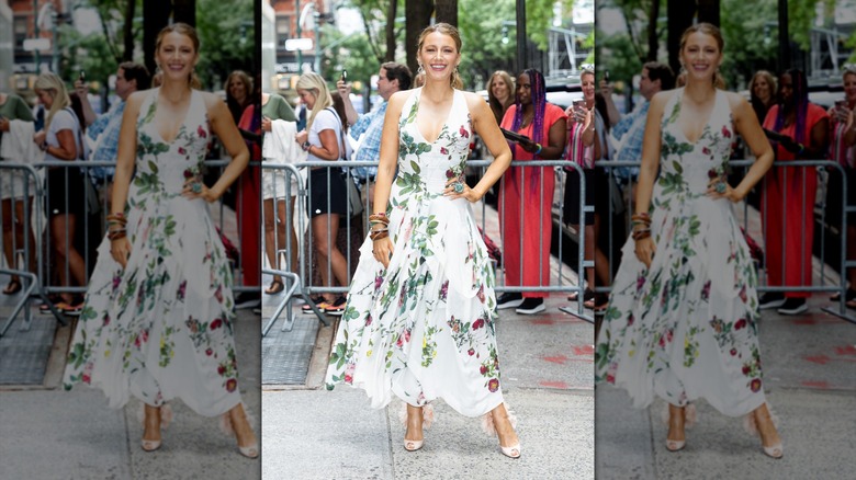 Blake Lively posing in a white floral summer dress