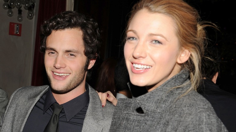 Penn Badgley and Blake Lively photographed smiling together.