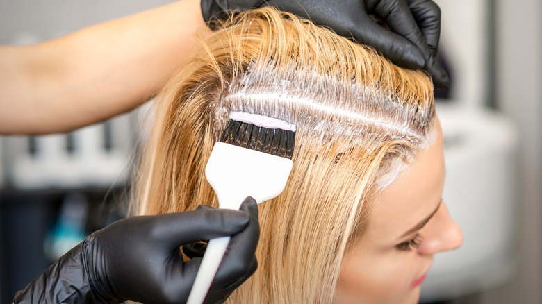 Woman bleaching hair