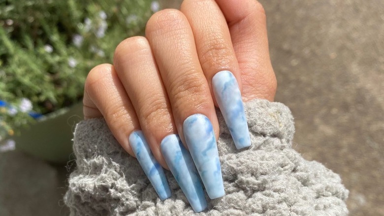 hand with blue lace agate nails