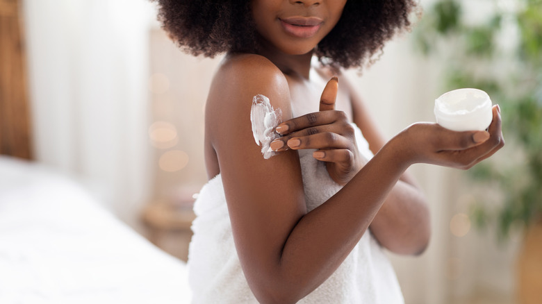 woman applying body cream