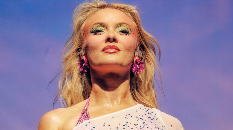 Zara Larsson posing for a photo with glittery eye makeup