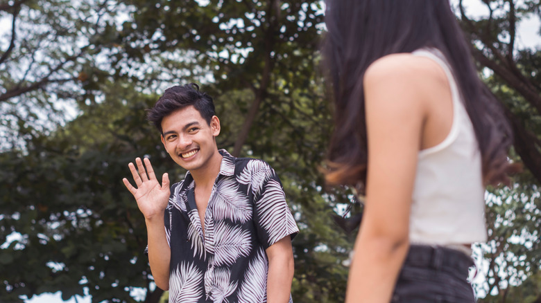 Nervous guy waving at his crush