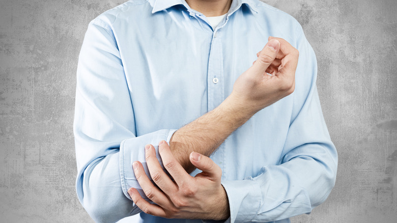 Man rolling up his sleeves