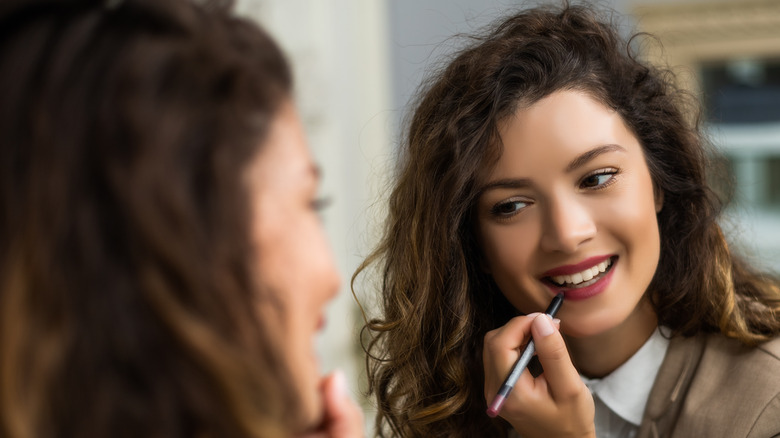 woman applying lip liner