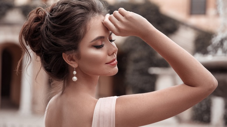 Woman wearing large pearl earrings