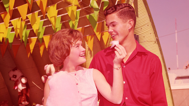 Teen couple at a carnival in the 1950s