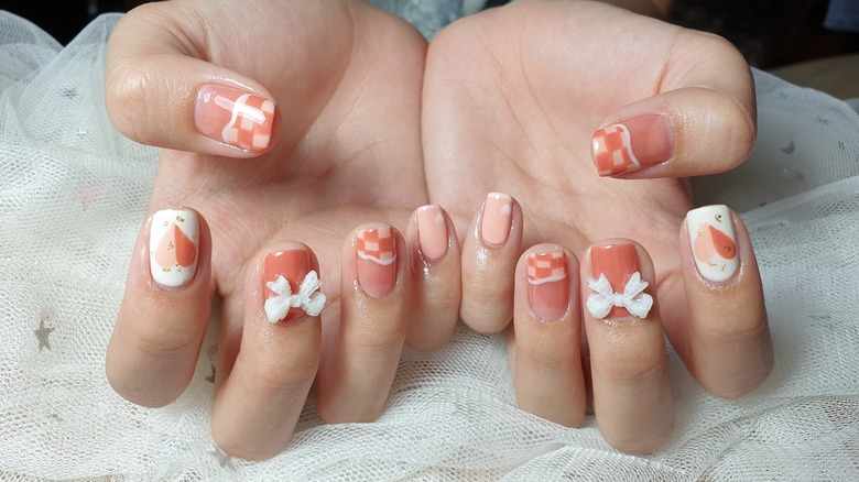 peachy square nails with bows