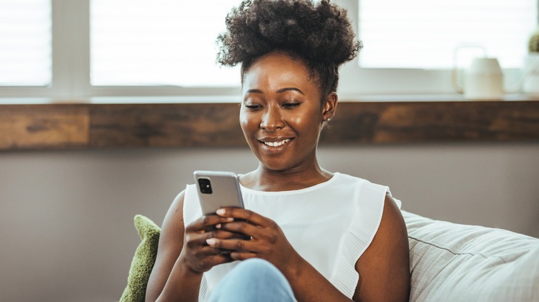 Woman smiling and texting