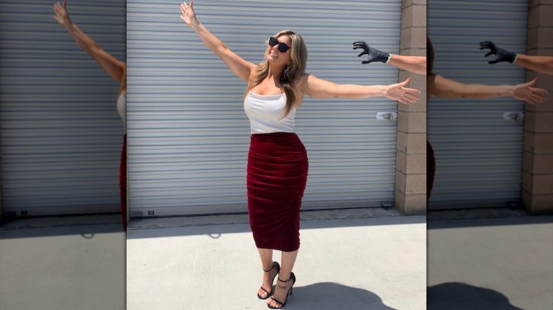Brandi Passante posing in a red skirt and top